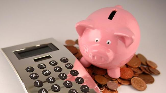 Piggy bank with calculator and some coins