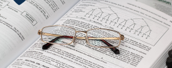 a pair of glasses resting on an accountancy textbook